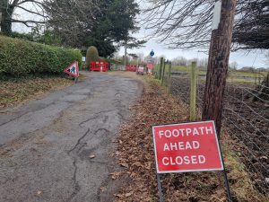 A footpath with a "footpath ahead closed" sign in the foreground